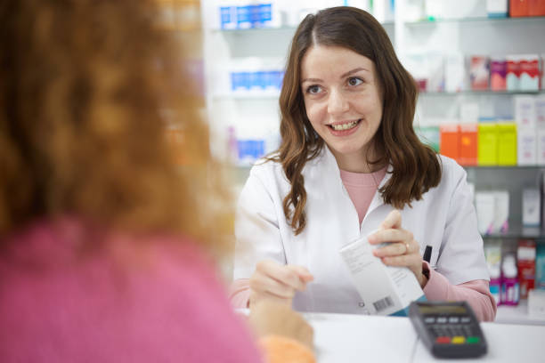 pharmacist talking to customer about medicine