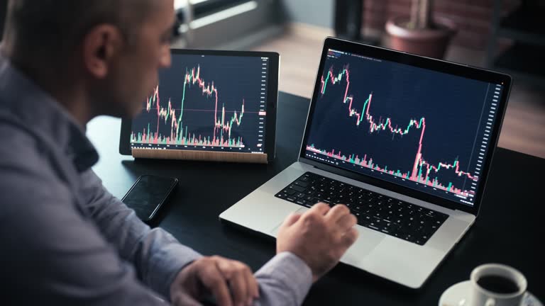 man checking his stock market exchange investment using his laptop computer.